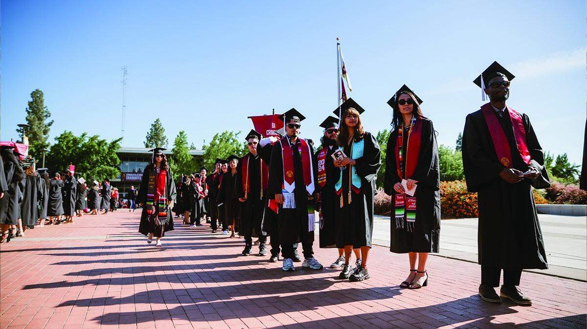 Graduating students line up for a 2024 commencement ceremony at Stanislaus State University in Turlock.
