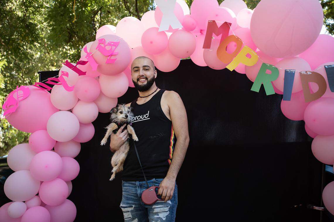Rafa Arroyo poses for a picture with his dog Bella during the MoPride festival at Graceada Park in Modesto, Calif., Saturday, Oct. 1, 2022.