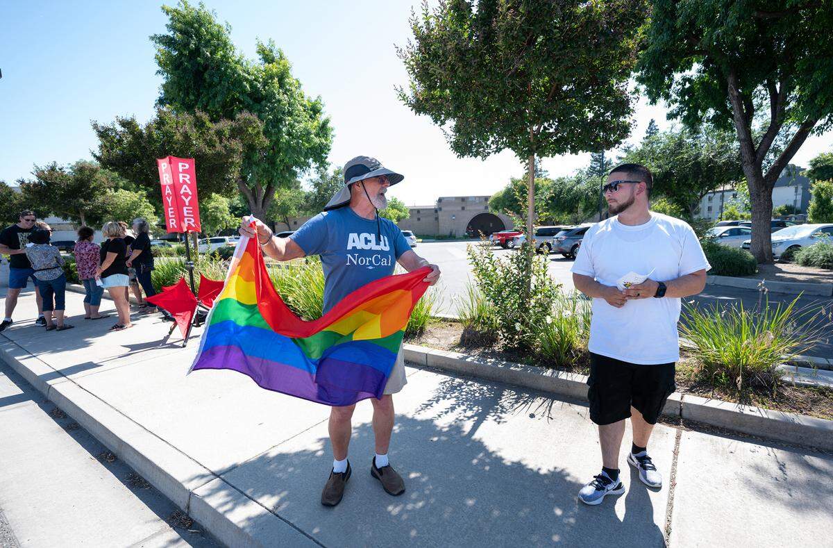 Tom Crain, left, shows his support for the LGBTQ+ community as he talks with David C., a member of First Church in Ripon, outside the Salida library during it’s Rainbow Story time at the Stanislaus County Library in Salida, Calif., Thursday, June 15, 2023.