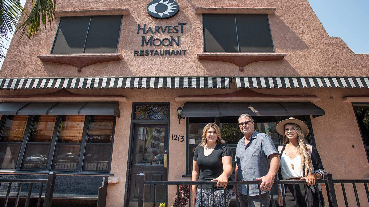New owners of Harvest Moon restaurant Marilyn Prescott, right, and Jessie Wiggins, left, stand with former owner Mark Smallwod, middle, in Modesto, Calif., on Friday, August 28, 2020.