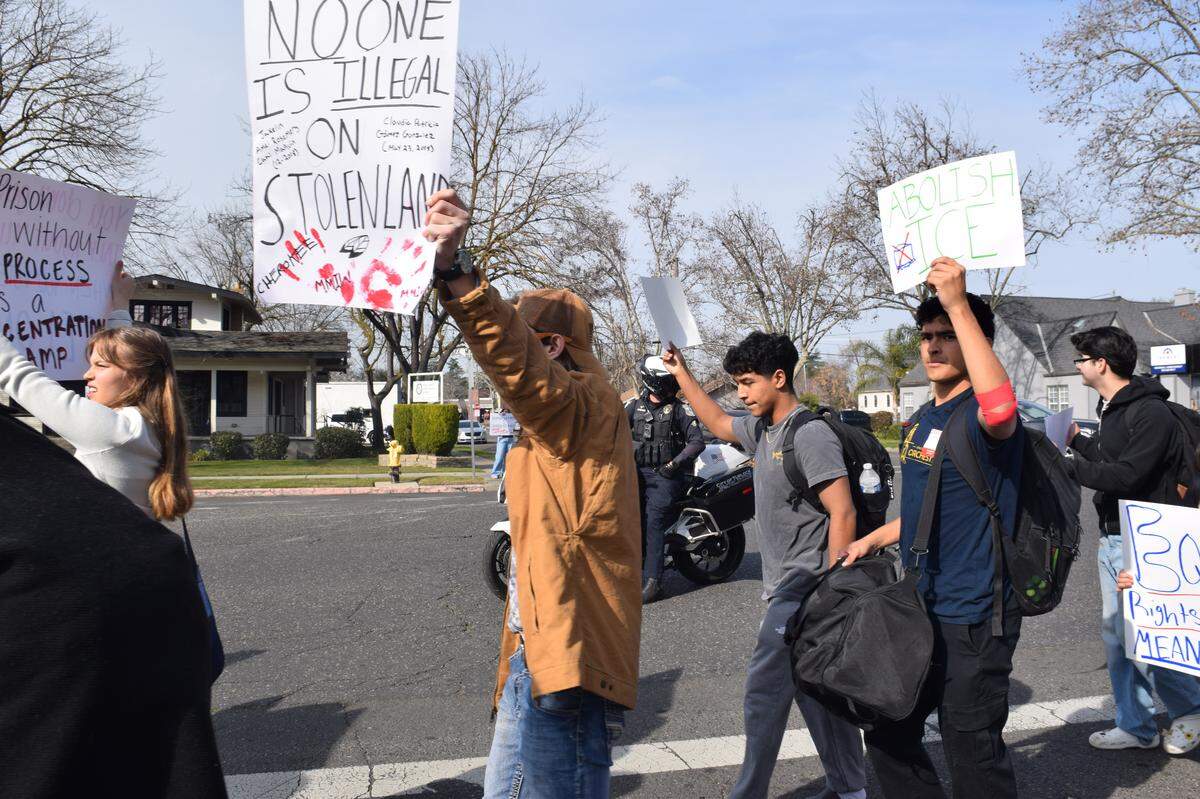 Students march to Central Park in Turlock as police officers patrol nearby on Friday, Jan. 30, 2026.
