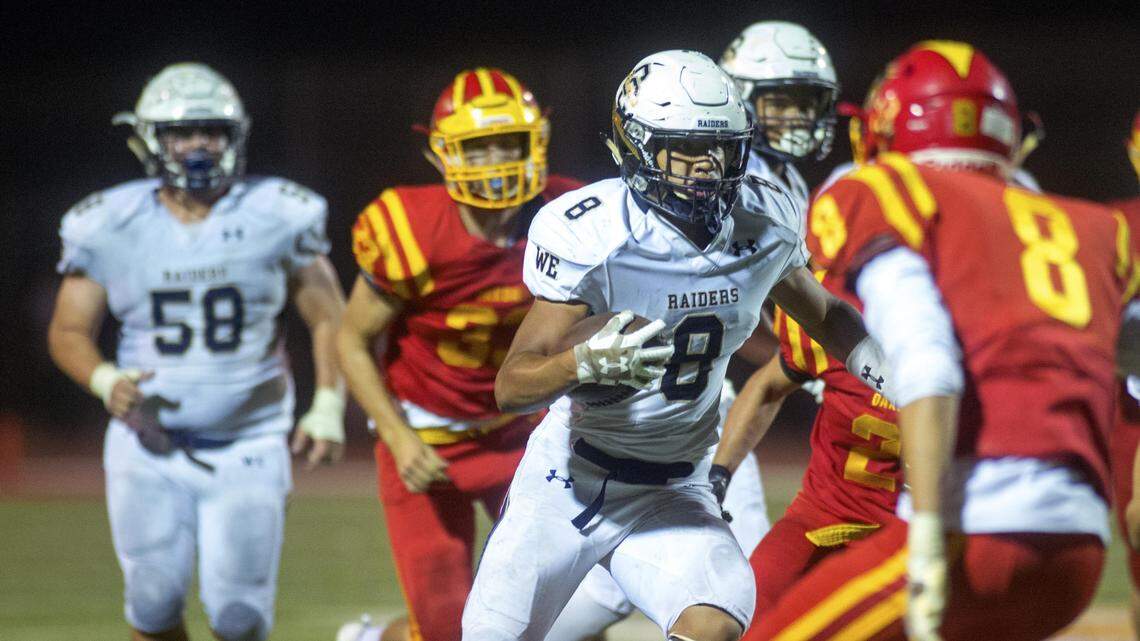 Central Catholic running back Minaya Olivo (8) runs through the Oakdale defense during a game between Central Catholic and Oakdale at Oakdale High School in Oakdale CA on October 26, 2018