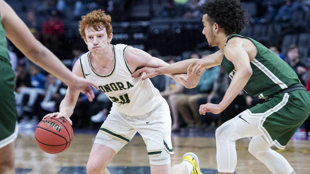 Sonora’s Austin Patterson looks to pass the ball as Liberty Ranch’s Jalen Patterson defends during the Sac-Joaquin Section Division IV boys basketball championship game at the Golden 1 Center in Sacramento, Calif., on Thursday, Feb. 27, 2020. Sonora won the game 70-57.