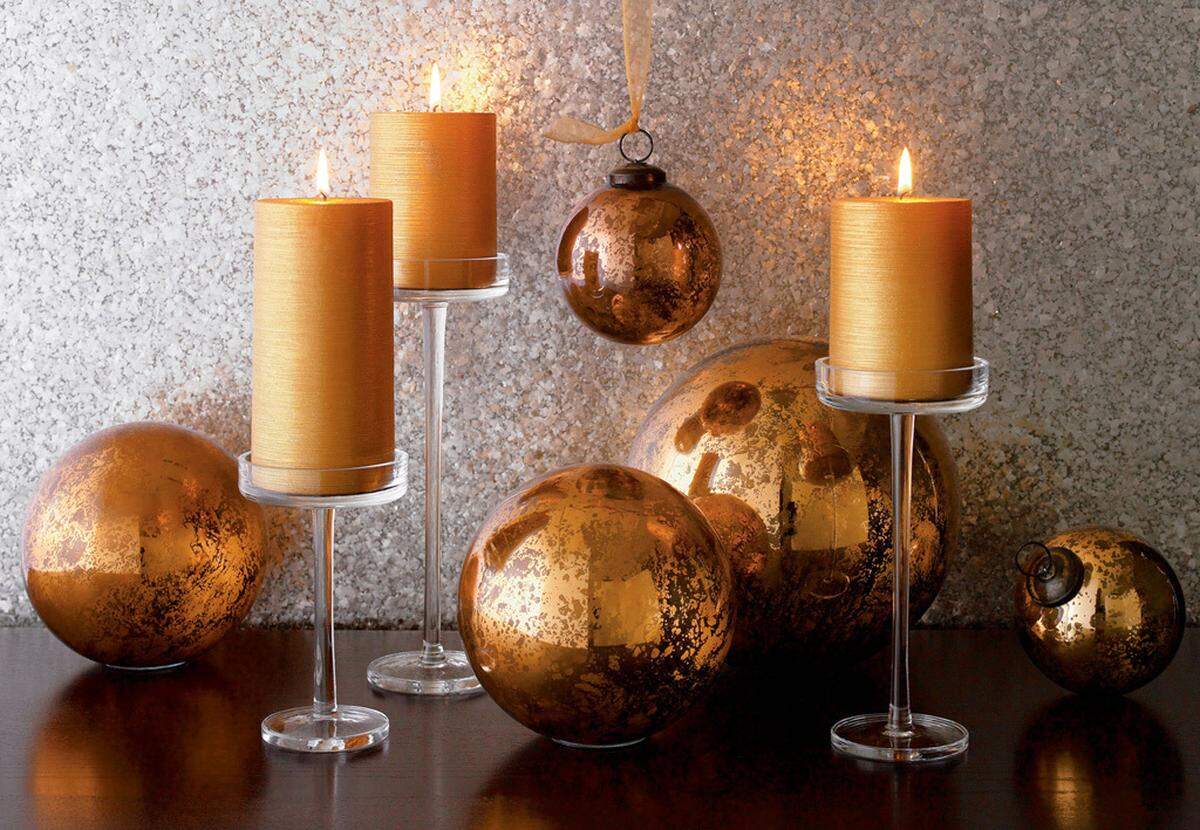 Crate & Barrel's Mercury Glass Copper Balls paired with Vienna Pillar holders add antiqued shimmer to either a tabletop or your tree. (Fort Worth Star-Telegram)