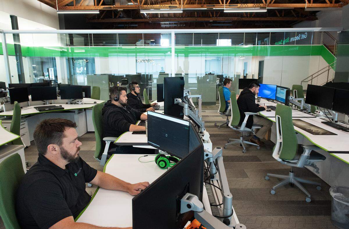 Services team lead Steven Unruh, left, and other team members work at the Datapath headquarters in Modesto, Calif., on Friday, April 22, 2022.