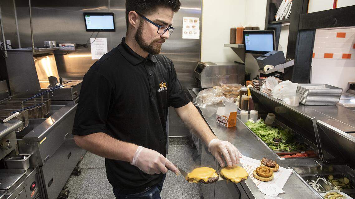 Dominic Dougherty makes burgers at Burgerim restaurant in Modesto, Calif., on Friday, March. 7, 2020.