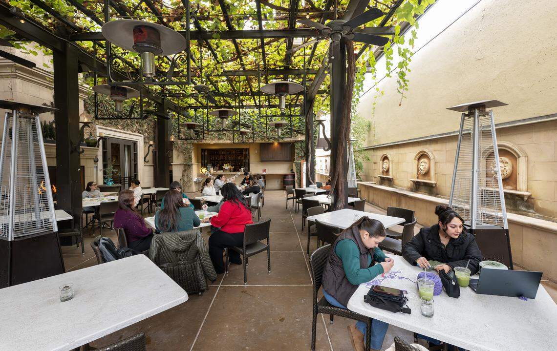 Lily Mejia and Ariana C., right, crochet on the patio of the Flora Cafe at Galletto on J Street in Modesto, Thursday, Nov. 20, 2025.