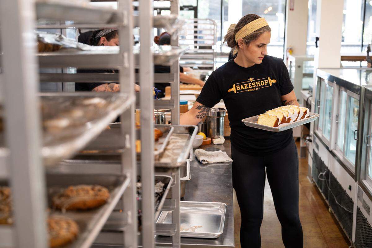 Owner and baker Ashley Olson stocks the pasty cabinet at Bakeshop bakery in Modesto, Calif., Thursday, Oct. 12, 2023.