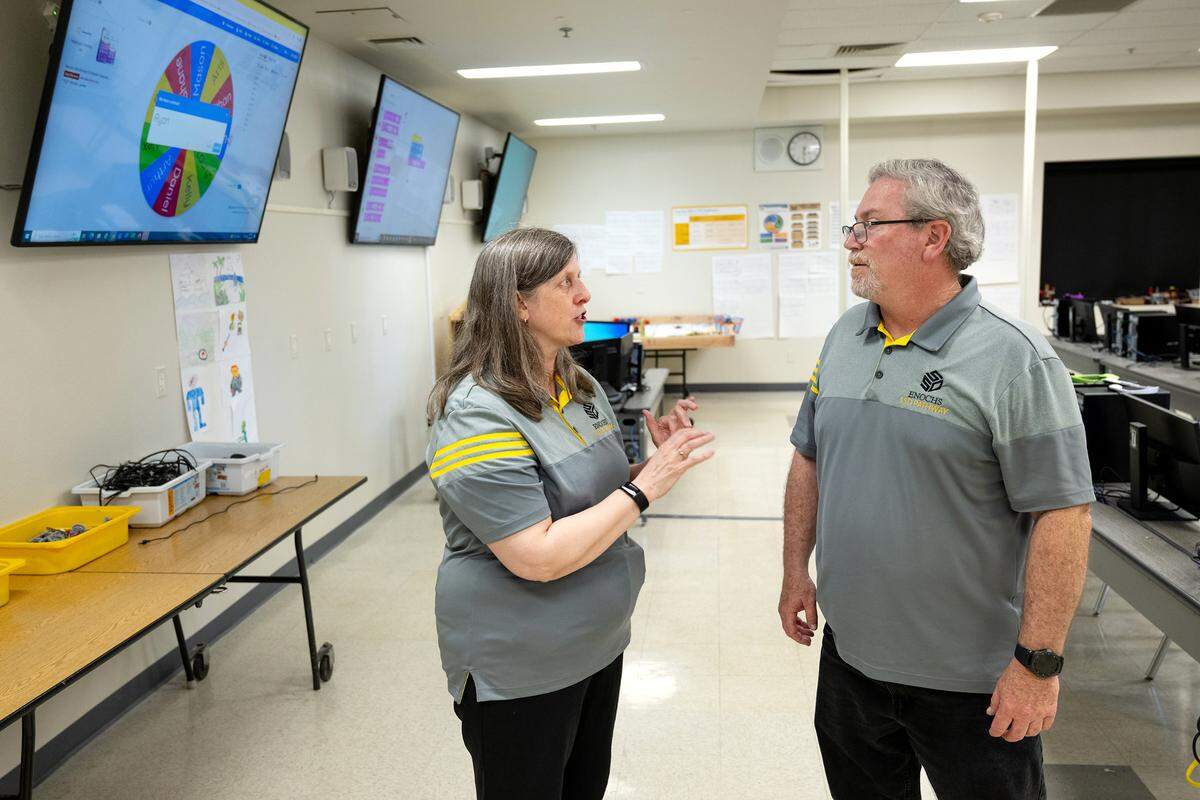 Computer science teachers Amy Pezzoni, left, and Kevin Richardson talk during a computer science Hackathon at Enochs High School in Modesto, Calif., Saturday, May 11, 2024.