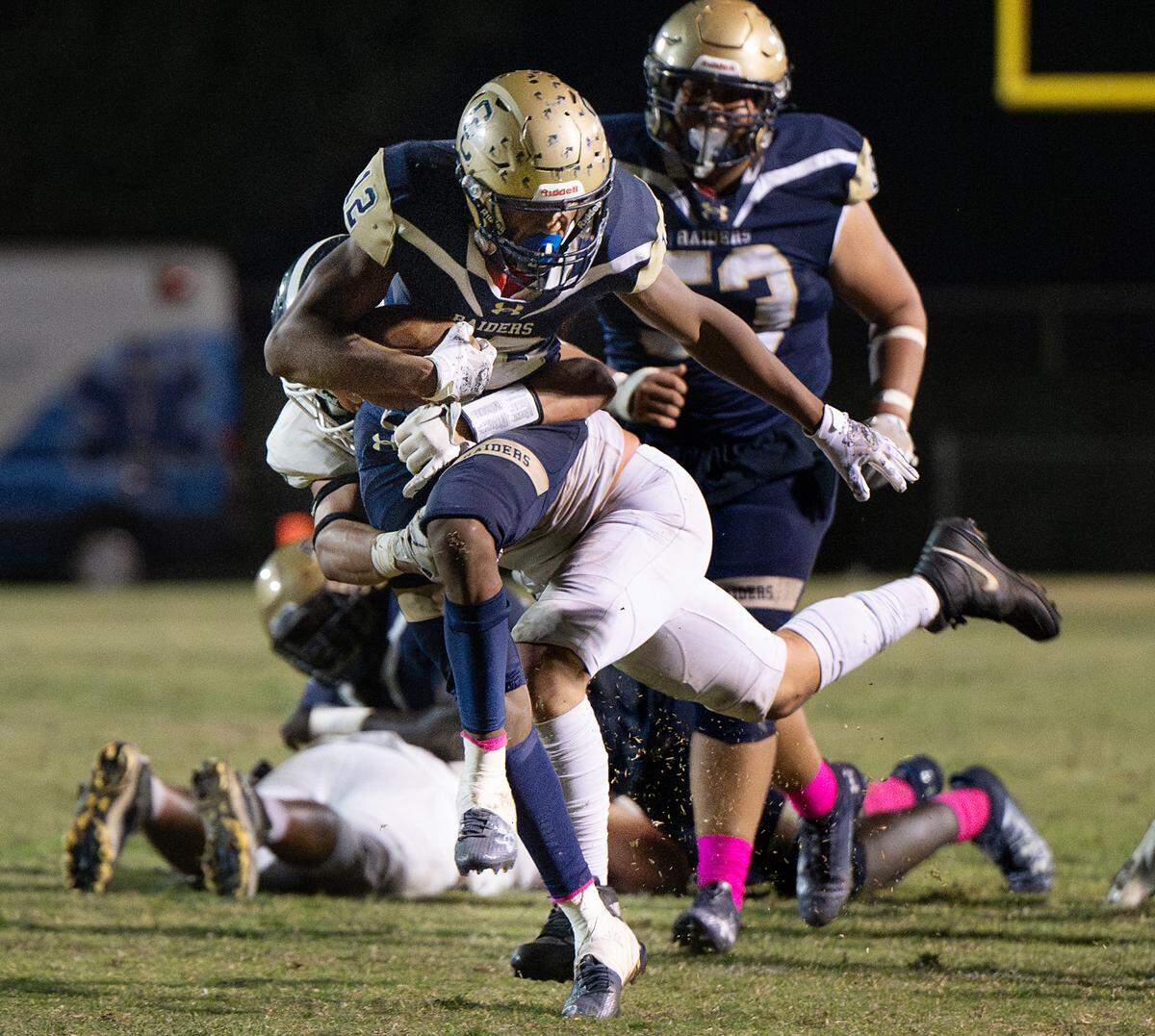 Manteca’s Daniel Bernal wraps up Central Catholic’s Joey Alcutt on a run during the Valley Oak League game at Central Catholic High School in Modesto, Calif., Friday, Oct. 20, 2023. Central Catholic won the game 39-35.