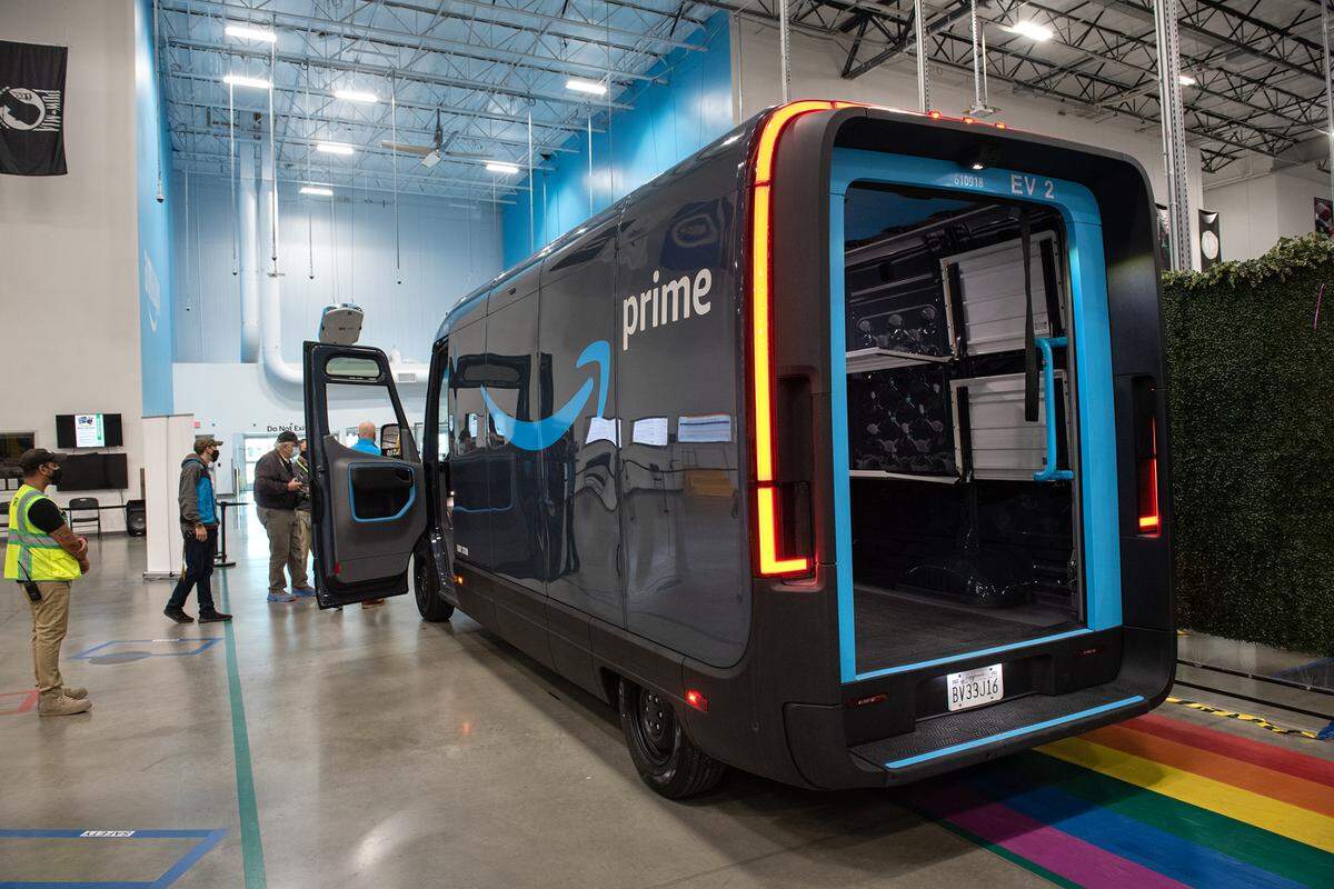 Custom built delivery vans made by electric car maker Rivian at the Amazon robotic sort center in Tracy, Calif., Thursday, Nov. 10, 2022. Amazon plans to transition to an all electric fleet of 100,000 delivery vans by 2030.