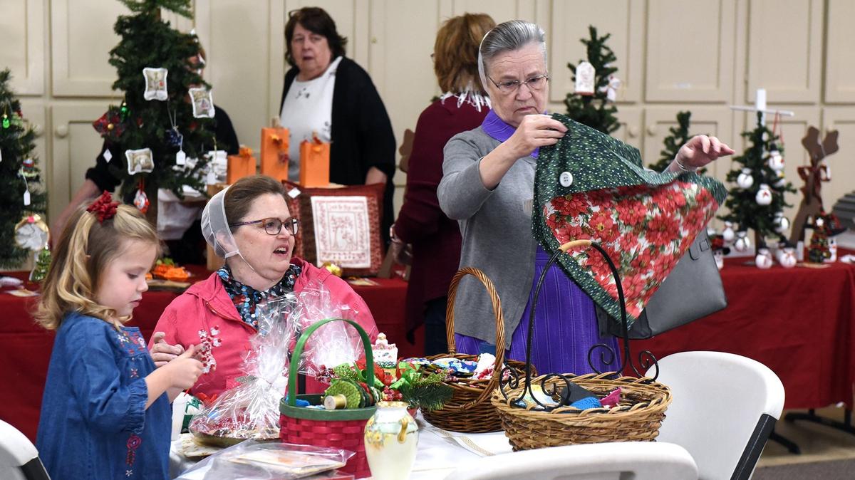 Marilyn Gish (right) looks at an item Friday November 2, 2018 as Julie Gish and Madelyn Bowman 4yrs (left) decide on their items at the Holiday Bazaar that runs today and tomorrow from 9am-3pm at Grace Lutheran Church in Modesto, Calif.