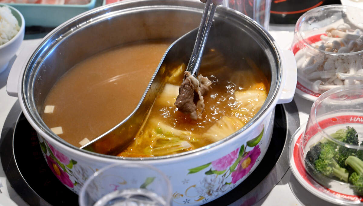 Thinly sliced meat and vegetables are cooked in a pot of broth at Hawai’i Pot Shabu Shabu House in Modesto, Calif., Tuesday, May 14, 2024.