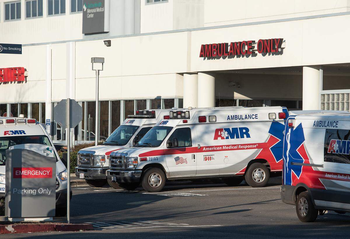 AMR ambulances are parked outside the emergency department at Sutter Memorial Medical Center in Modesto, Calif., on Tuesday, Jan. 25, 2022.