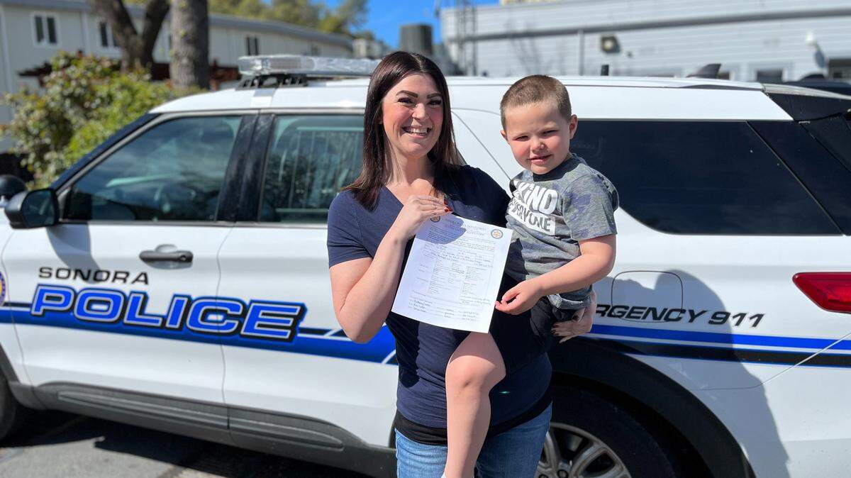 Brittaney Sutton and her son Wyatt in front of a Sonora Police car. Sutton worked with the department to formulate an Autism Safety Alert Form.