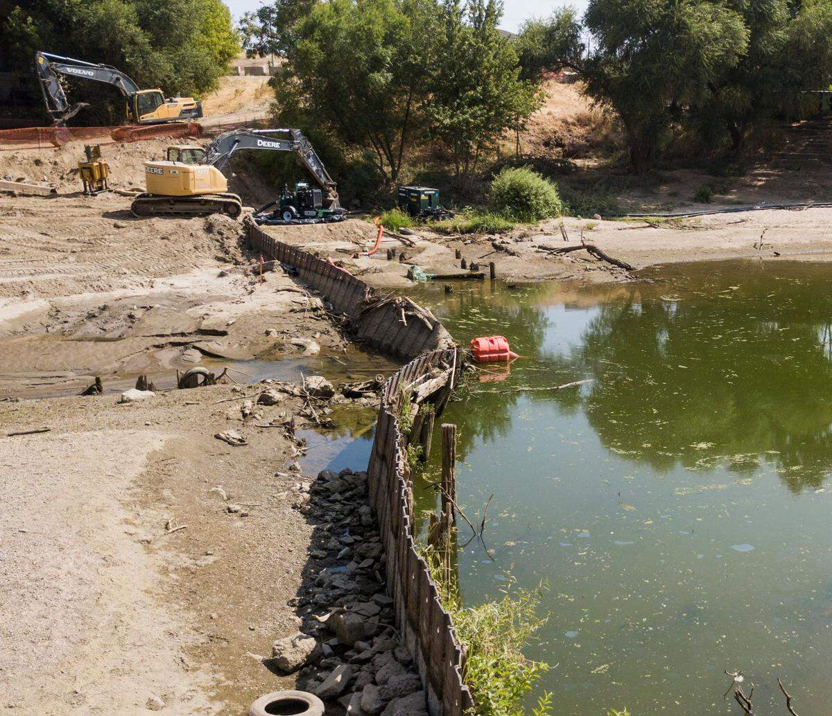 The removal of the Dennett Dam along the Tuolumne River near the 9th Street bridge is under way. The Tuolumne River has been diverted to the north and around the dam to allow the removal. 