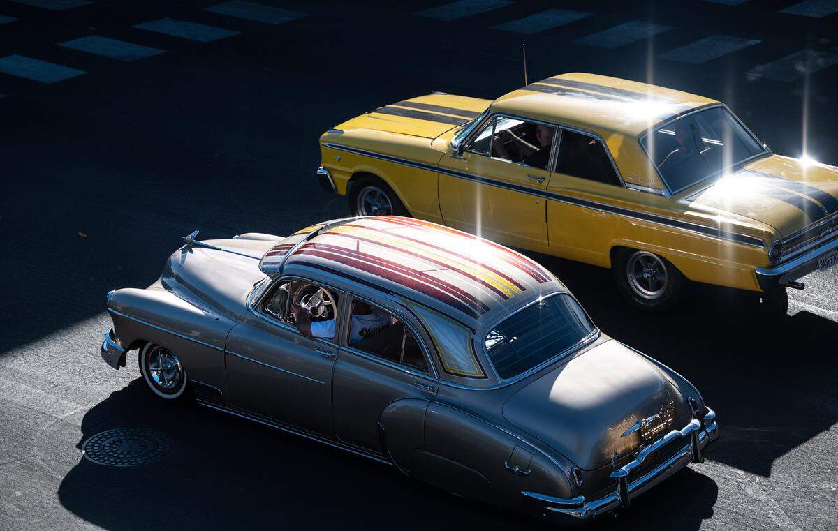 Classic car owners cruise along J Street during the North Modesto Kiwanis Club’s “American Graffiti” car parade in Modesto, Calif., on Friday, June 10, 2022.