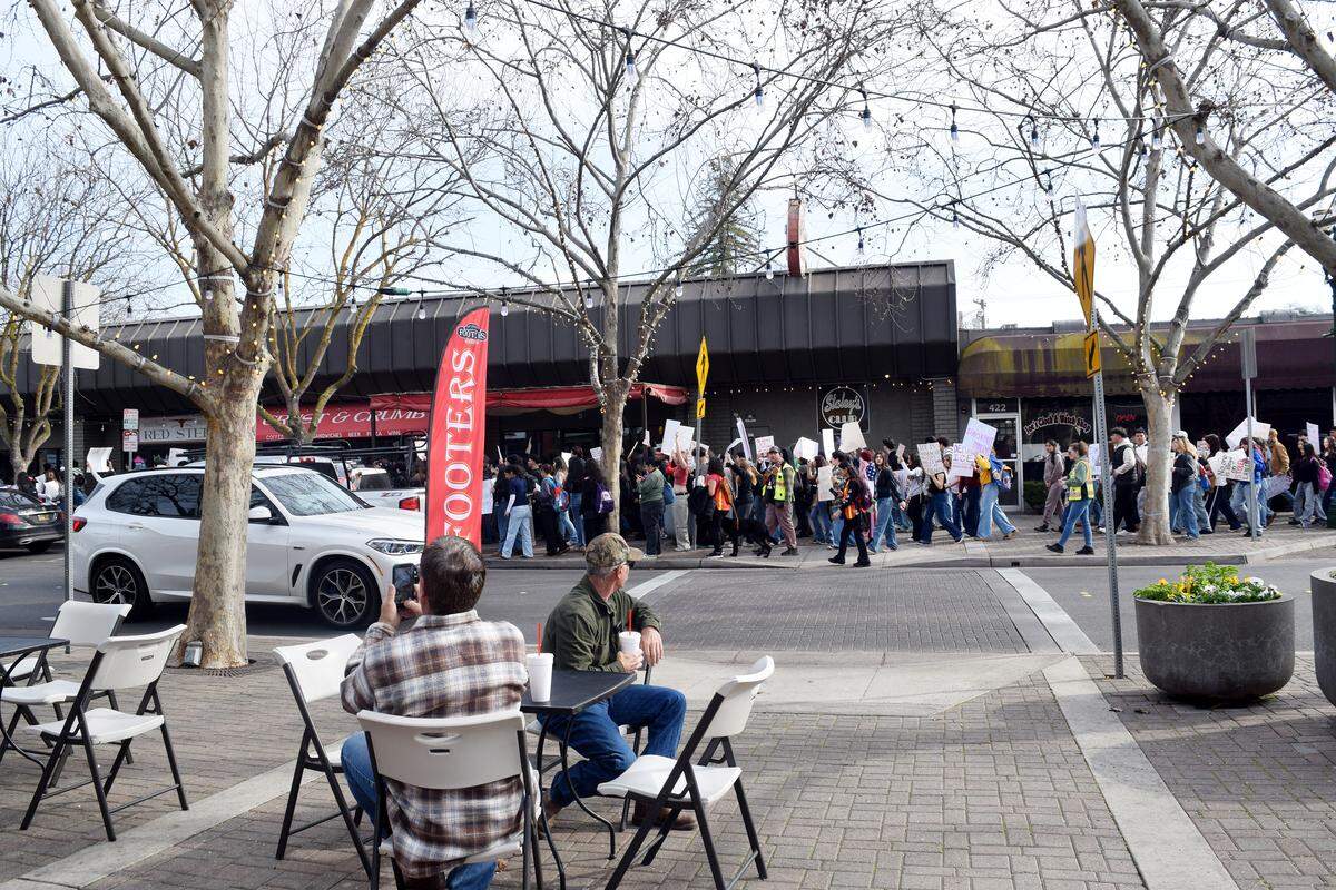 Residents watch as students march through downtown Turlock in solidarity of Minneapolis on Friday, Jan. 30, 2026.