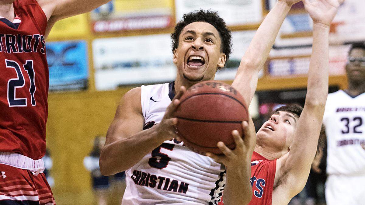Modesto Christian's Junior Ballard scores on a layup past Beyer's Kris Fore during the Modesto Metro Conference game in Salida on Wednesday, Jan. 24, 2018.