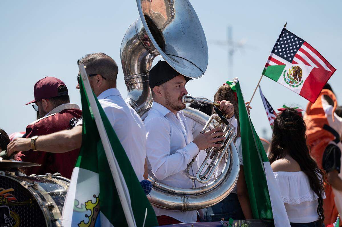 Musicians from Tamborazo Rancho Alegre perform on a rolling flatbed truck during the Cinco de Mayo parade on Crows Landing Road in Modesto, Saturday, May 7, 2022.