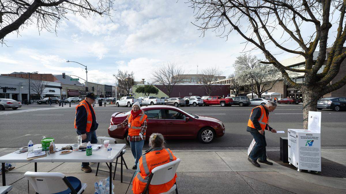 Election volunteers collect ballots at a drive-up ballot drop station outside the Gallo Center for the Arts in Modesto, Calif., Tuesday, March 5, 2024.