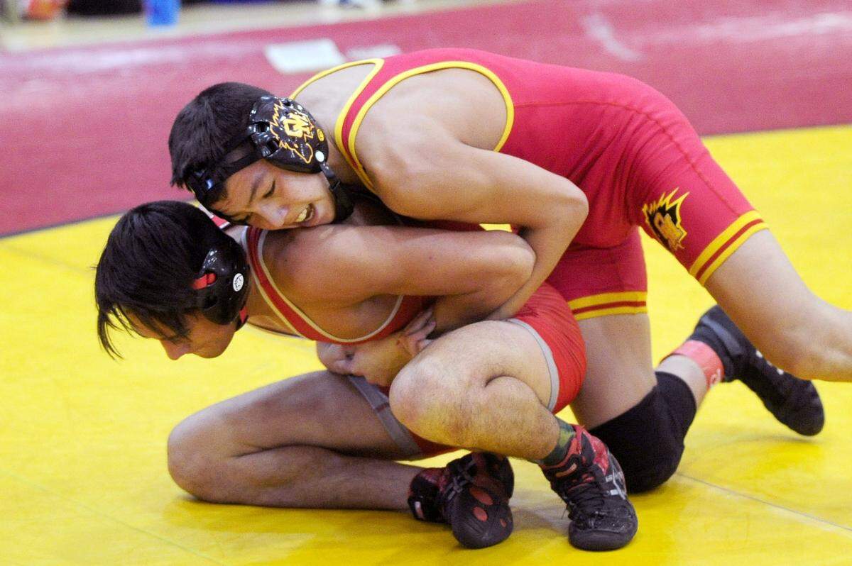 Oakdale wrestler Caesar Garza, right, keeps a tight hold on Foothill wrestler Jake Bergstrom, on Saturday, December 9, during the James Riddle Memorial Wrestling Tournament at Oakdale High School.