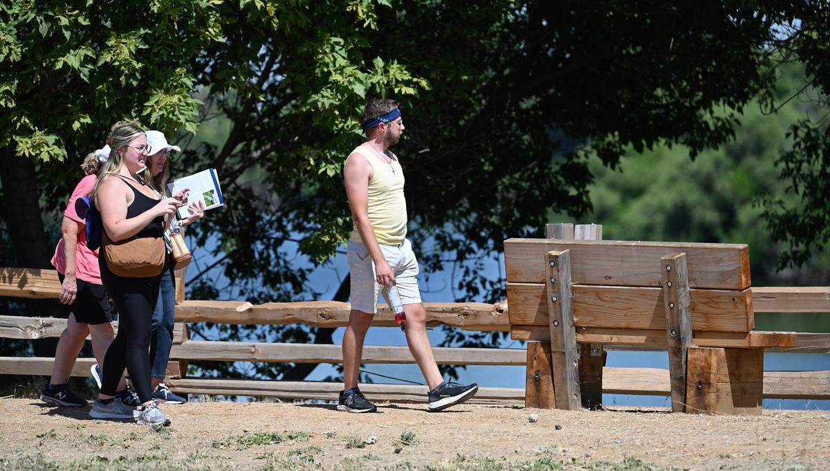 Visitors walk along the half-mile path bordering the pond during the opening of Dos Rios State Park in Modesto, Calif., Wednesday June 12, 2024.