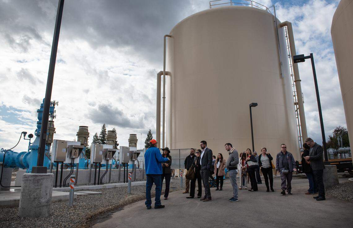 Officials from state and federal Environmental Protection Agencies tour the water treatment plant in Keyes, Calif., Wednesday, Nov. 2, 2022. The drinking water system for Keyes is getting $20.4 million from the federal infrastructure bill for water treatment projects.