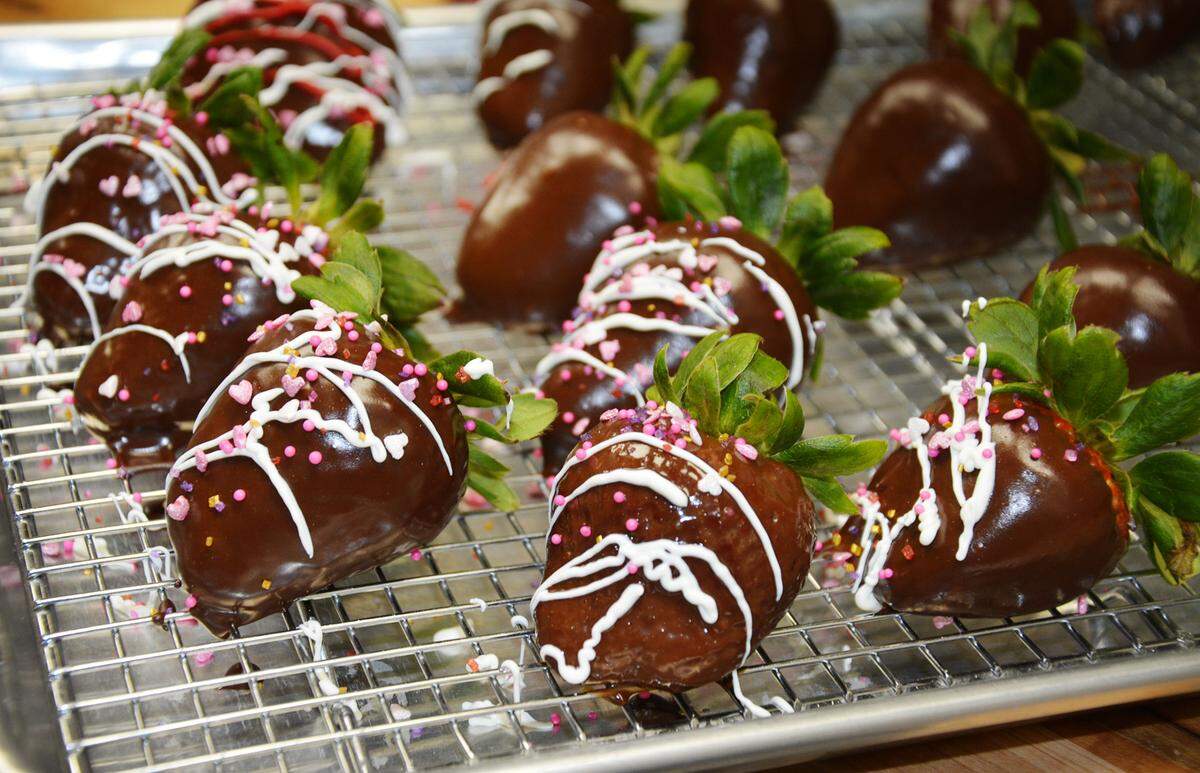 Fresh hand-dipped chocolate strawberry being made at Palo Santo Cafe in Riverbank, Calif. Feb. 23, 2021.
