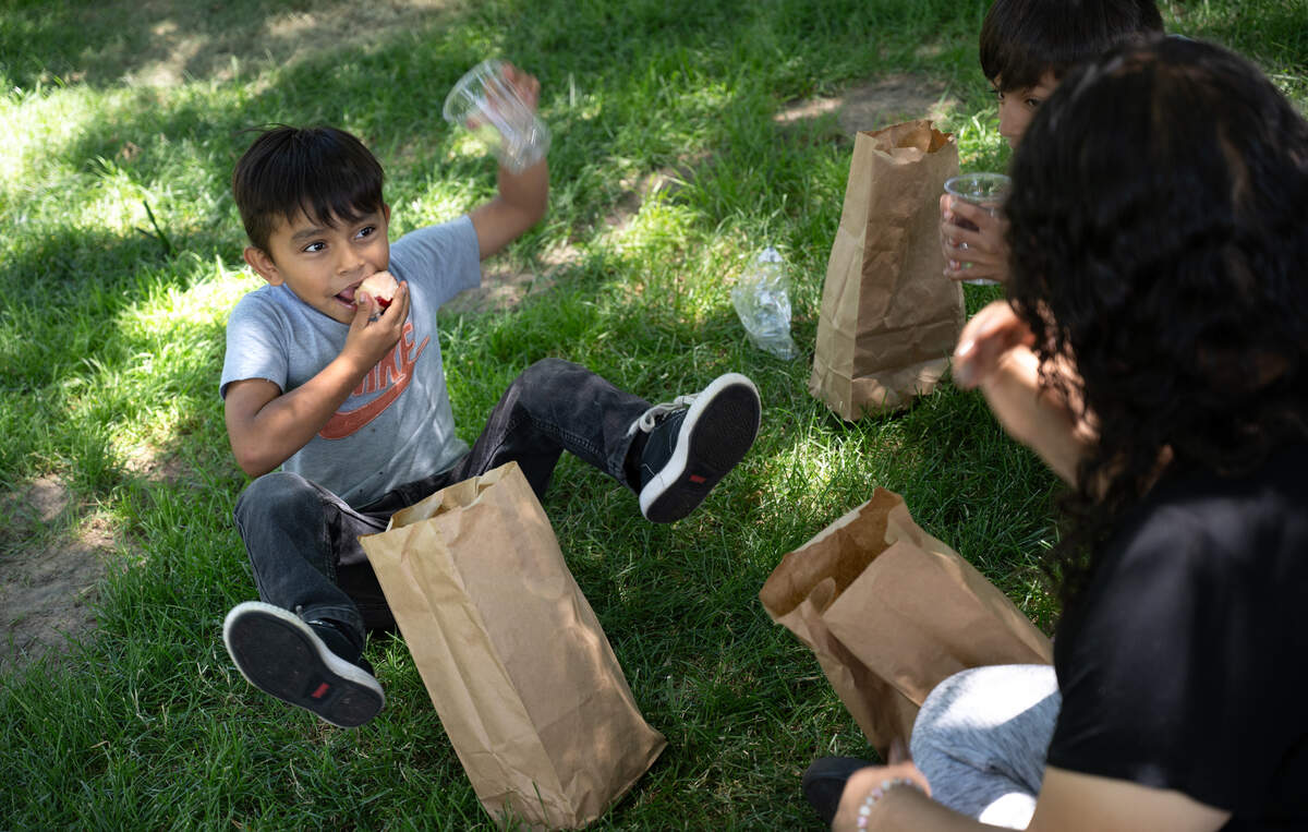 Adolfo Andrade, 6, has fun while eating a nectarine after being served by the Modesto City Schools’ summer lunch program at Mark Twain Park on California Avenue in Modesto on June 25, 2024.