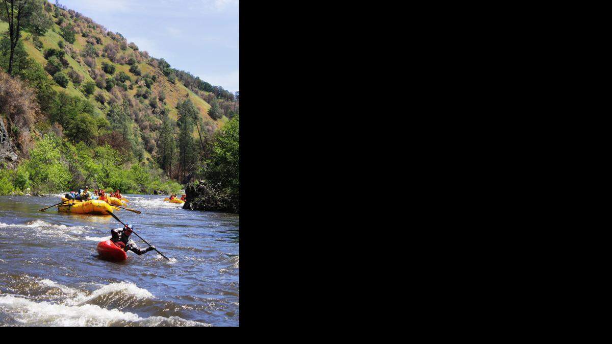 Rafters guided by OARS, an outfitter based in Angels Camp, Calif., make their way down the Tuolumne River in early May 2014. The stretch is within the area burned by the Rim fire last year, but the riverside vegetation was not severly damaged.
