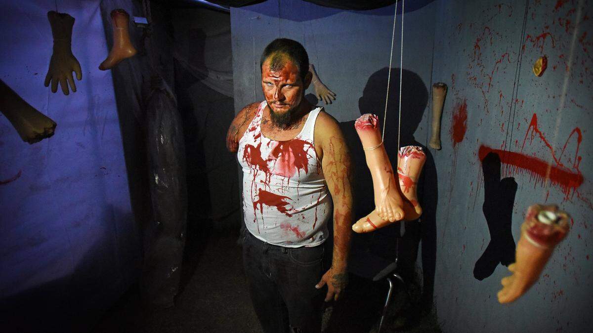 Enrique Gastelo plays a one-armed man in the haunted house at the Ranch of Horrors on the Stanislaus County Fairgrounds in Turlock, Calif., on Thursday, Oct. 12, 2017.
