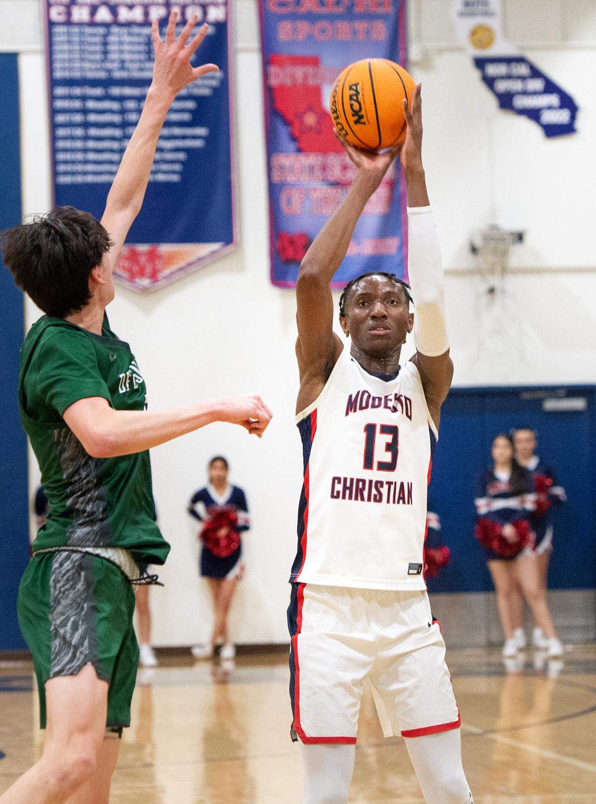 Modesto Christian’s Prince Oseya scores a three point basket during the NorCal Open Division semifinal playoff game in Salida, Calif., Saturday, March 4, 2023.