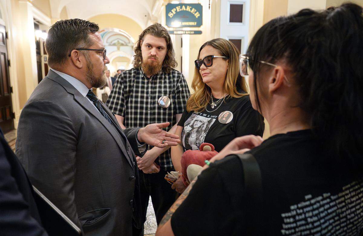 Assemblymember Juan Alanis, R-Modesto, talks with the family of Avery Millerick, including her brother Ethan Millerick, middle, and her mother, Ciara Walsh, right, outside the chambers at the Capitol in Sacramento, Thursday, Aug. 21, 2025.