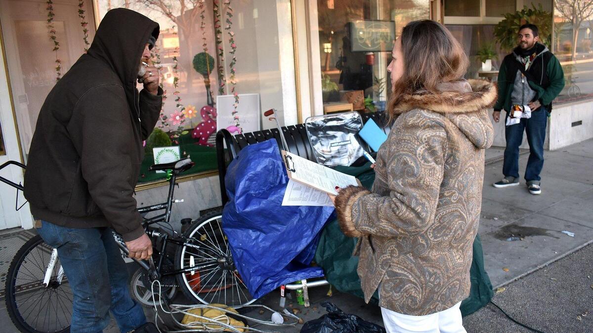 Deanna Garcia of Riverbank interviews two men, Bill (left) and Matt on Jan. 24, 2019, during the 2019 point-in-time count of the homeless in downtown Riverbank, Calif.