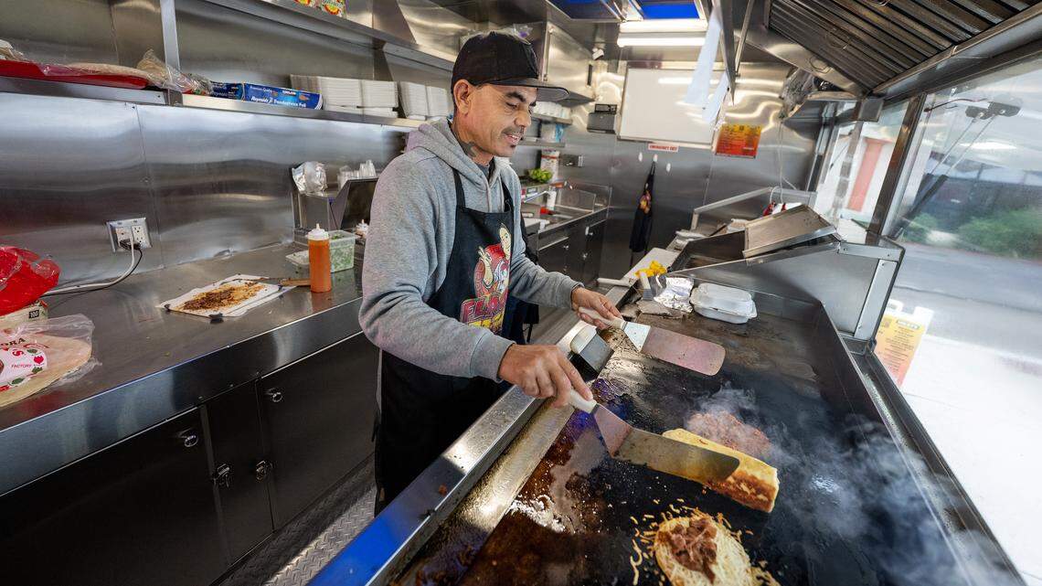 Owner Rafael Calvillo works the grill at Flaco’s Tacos food truck on Coffee Road in Modesto, Monday, Nov. 24, 2025. Calvillo is being forced to change the name of his business due to a trademark conflict.