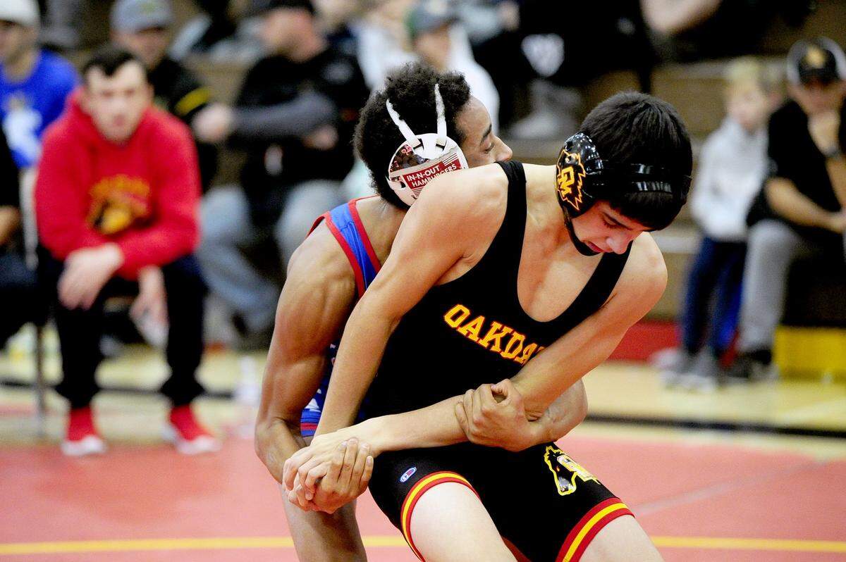Oakdale wrestler Brandon Abell tries to break the hold of Durham wrestler Yousuf Zigan, on Saturday, December 9, during the James Riddle Memorial Wrestling Tournament at Oakdale High School.
