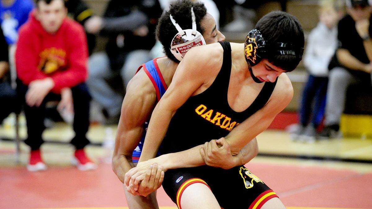 Oakdale wrestler Brandon Abell tries to break the hold of Durham wrestler Yousuf Zigan, on Saturday, December 9, during the James Riddle Memorial Wrestling Tournament at Oakdale High School.