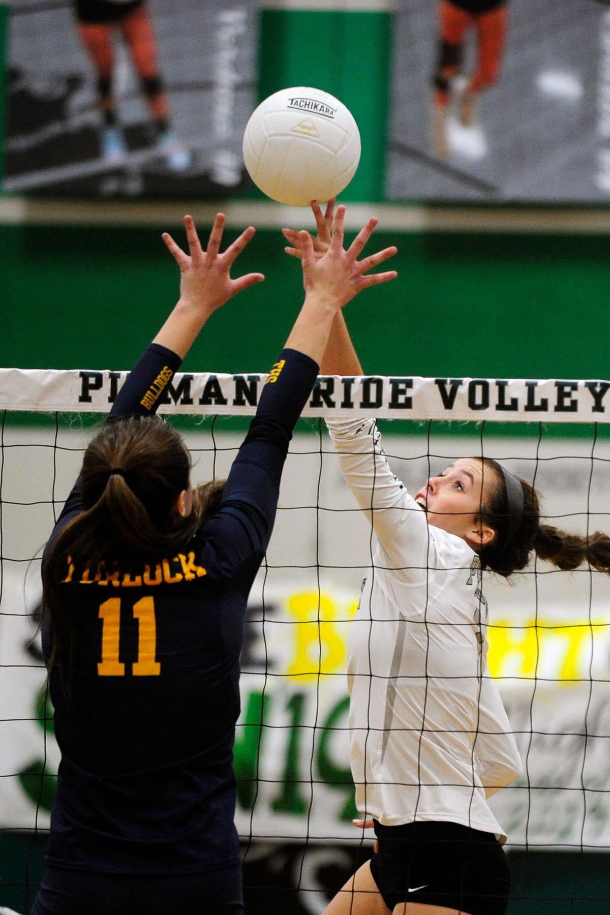 Turlock’s Beth Johnson (11) goes to block as Pitman’s Cierra Verdone (1) tips the ball, during the senior night, crosstown volleyball matchup of Turlock High at Pitman High, on Monday, Oct., 15 in Turlock, California.