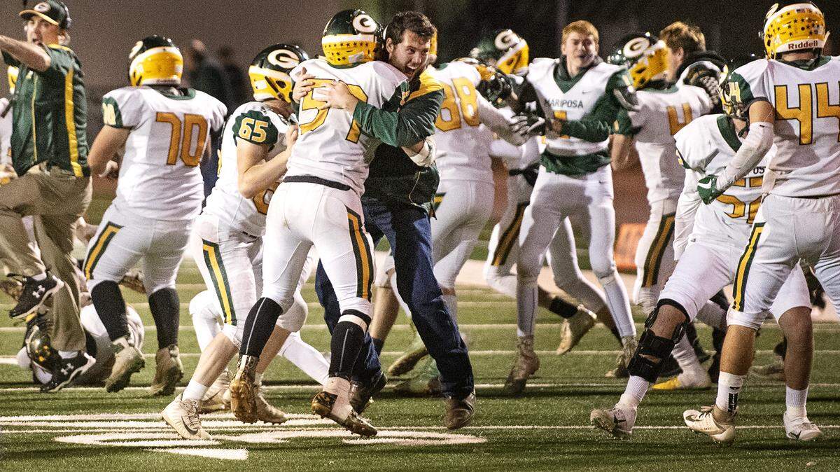 Mariposa players and coaches celebrate their 17-14 victory over Denair in the Sac-Joaquin Section Division VII championship game on Friday at Turlock High School in Turlock, Calif., Friday, Nov. 22, 2019.