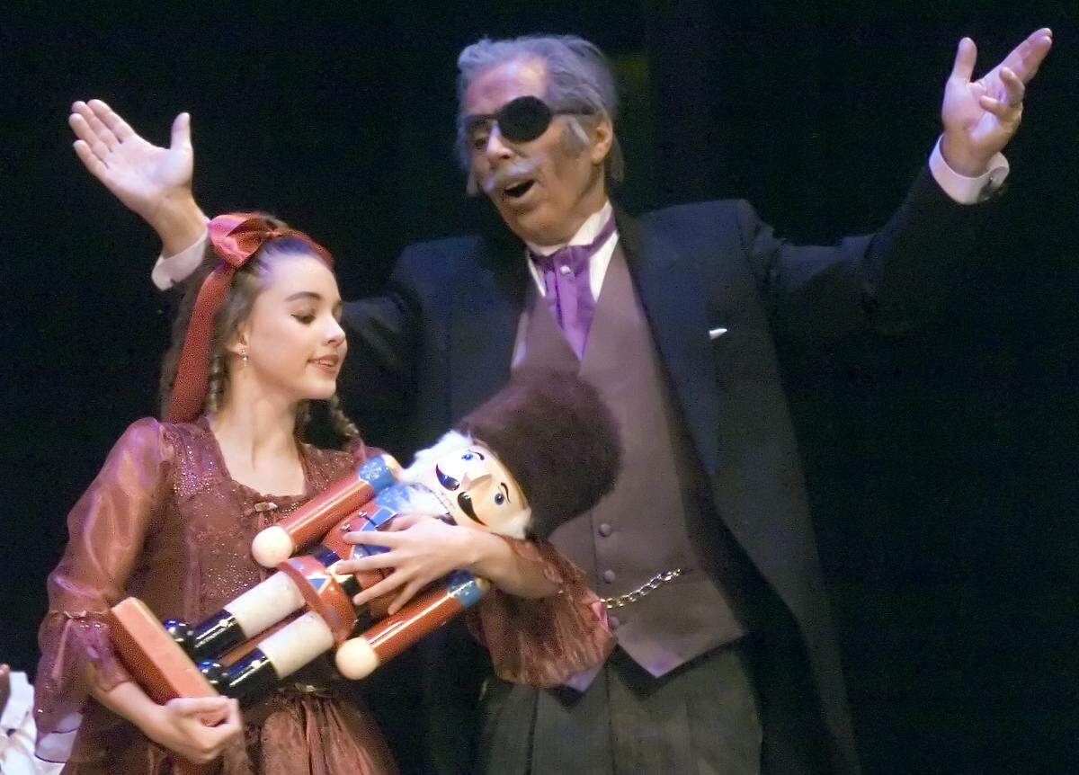 Drosselmeyer (Paul Tischer) gives Clara (Sarah Betts) a toy nutcracker during Central West Ballet's performance of "The Nutcracker" at Modesto High in 2006.