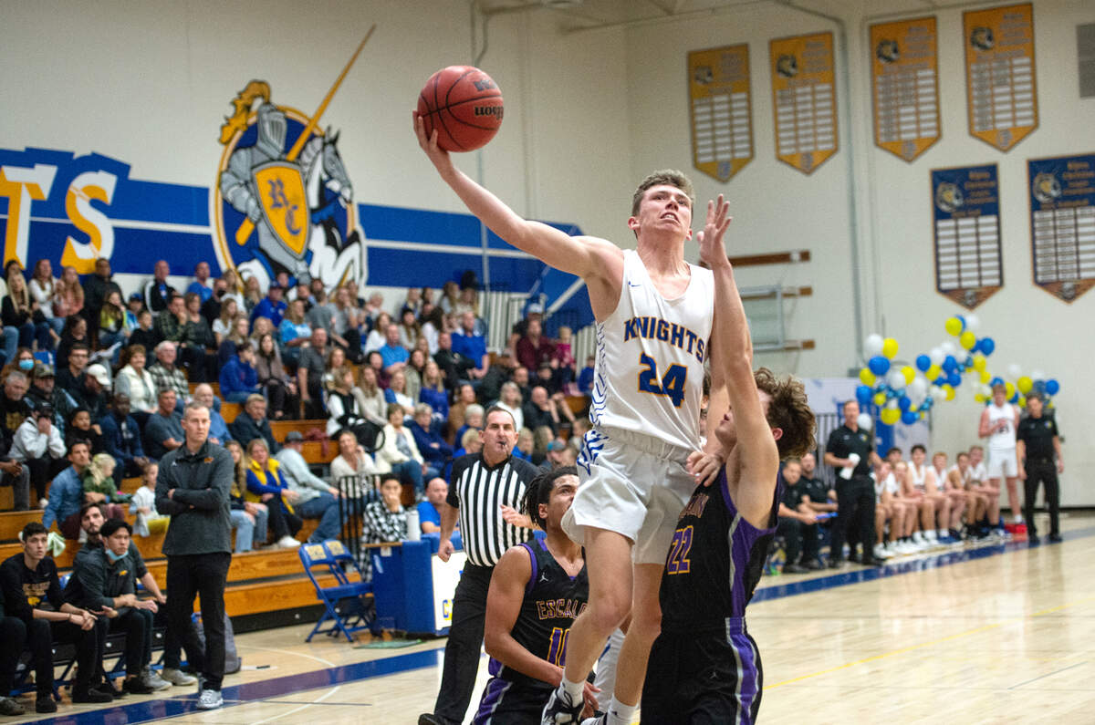 Ripon Christian’s Derek Van Elderen scores over Escalon’s Ben Fletcher during the Trans Valley League game at Ripon Christian High School in Ripon, Calif., on Friday, Jan. 7, 2022. Ripon Christian won the game 61-53.