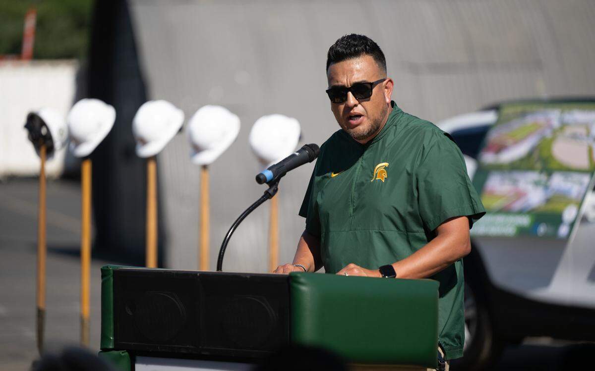 Davis Athletic Director Tim Garcia, right, speaks during a groundbreaking ceremony for new athletic fields and aquatic center at Grace Davis High School in Modesto, Friday, May 9, 2025.
