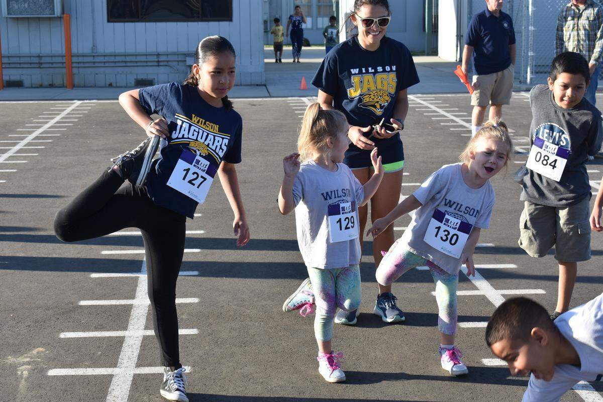 The first training run of the 10K With a Cop program was held Saturday, Sept. 22, 2018, at Shackelford Elementary School in Modesto. About 150 kids ran a mile with police officers, teachers, school administrators and others.Wilson Elementary student Stephany Guerrero stretches with other kids before the run.