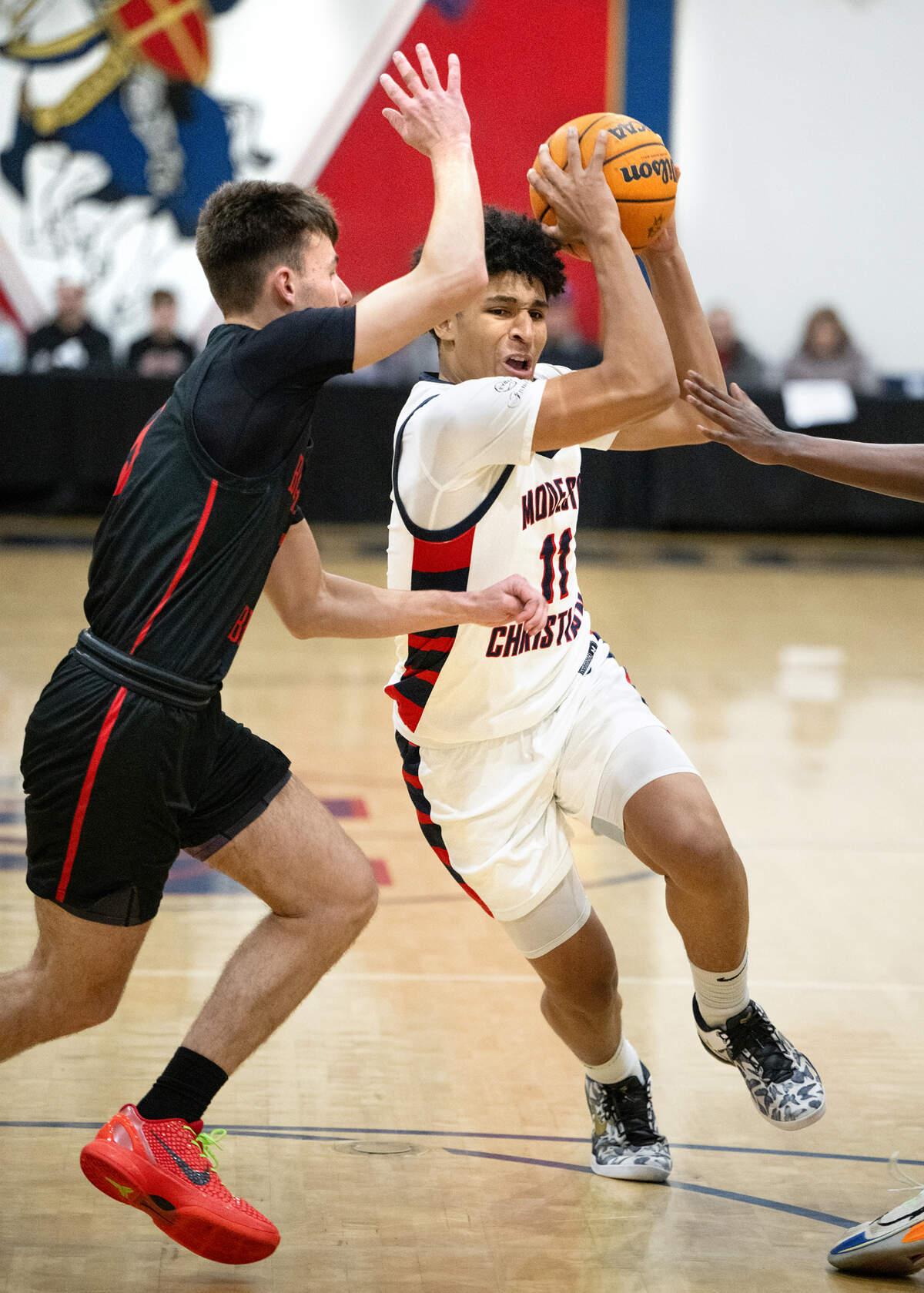 Modesto Christian’s Gavin Sykes drives to basket on Buchanan’s Dax Stout during the Holiday Hoop Classic championship game at Modesto Christian High School in Salida, Monday, Dec. 30, 2024.