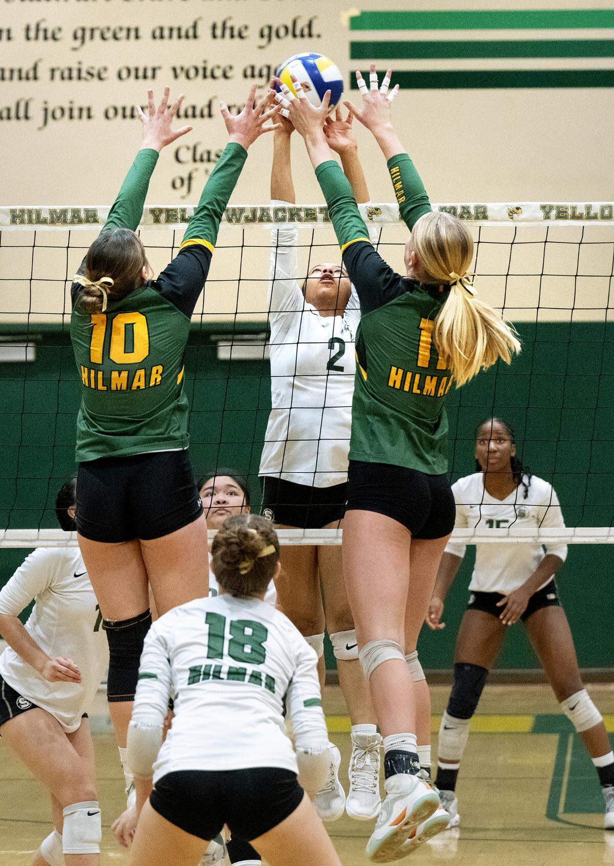 Hilmar’s Finley Rosa, (10) and Reese Ahlem (11) battle with St. Patrick-St. Vincent’s Tatiana Handy during the CIF Northern California Division IV volleyball championship match at Hilmar High School in Hilmar, Tuesday, Nov. 19, 2024.