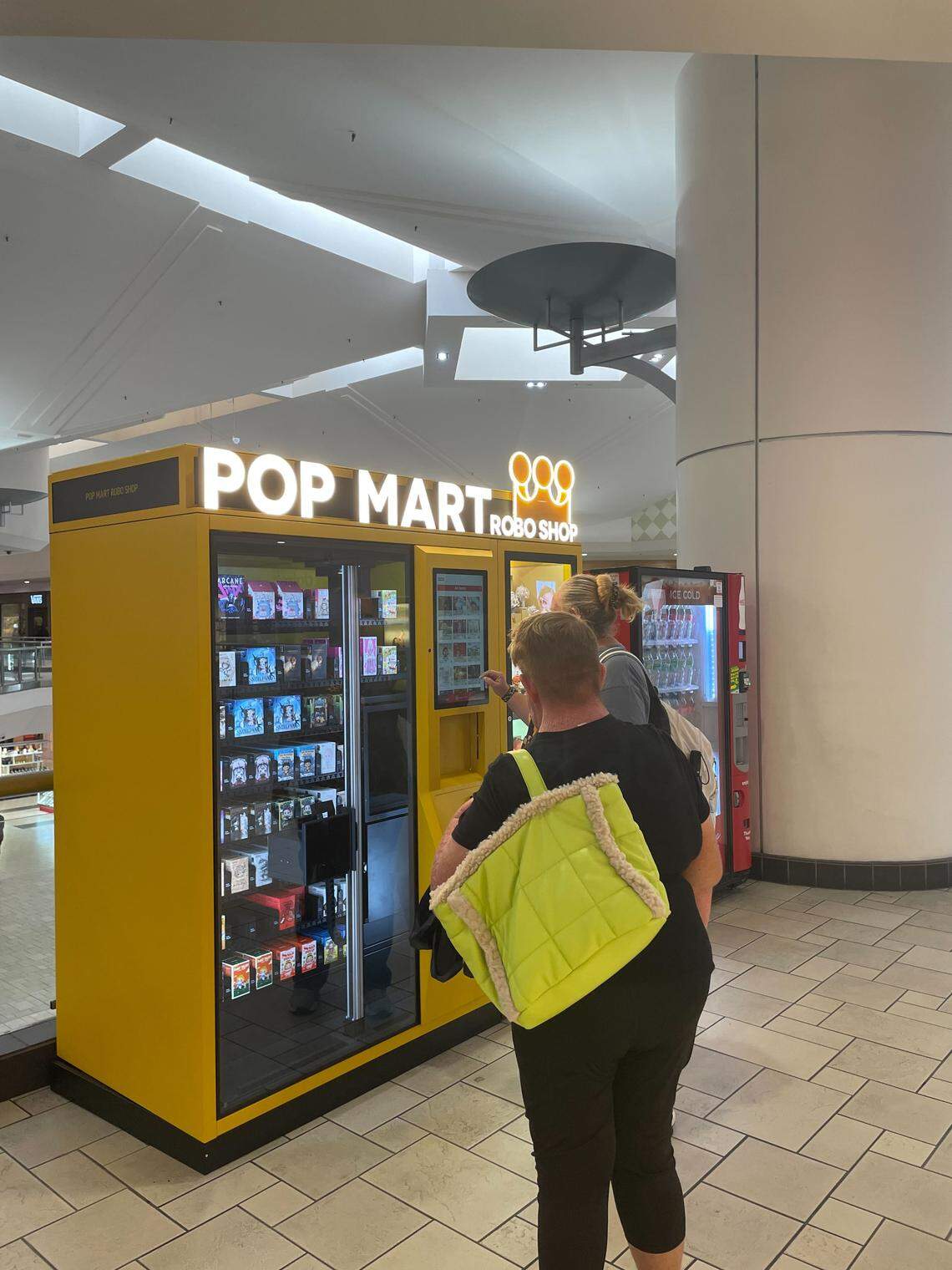 Shoppers check out the new Pop Mart Robo Shop vending machine at  Vintage Faire Mall on Tuesday, Oct. 14.