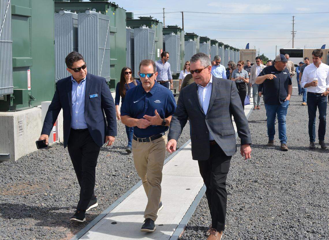 Allan Schurr, front right, chief commercial officer at Enchanted Rock, leads a tour of the emergency power plant it built in Modesto CA on June 3, 2024.