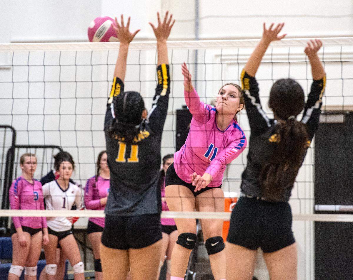 Beyer’s Raena Sharp hits past Lathrop defenders during the Western Athletic Conference match at Beyer High School in Modesto, Calif., Tuesday, Oct. 4, 2022. Beyer won 3-0.