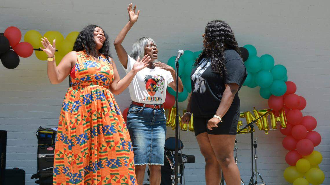 Christina Holmes, Patricia Woods and Jazlyn Jackson, left to right, from Victory in Praise church in Modesto sing during the city’s annual Juneteenth celebration in Graceada Park on Saturday, June 17, 2023.